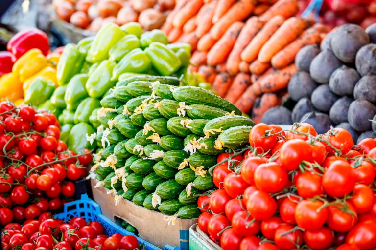 Stock image of lots of different colourful fruits and vegetables in a market