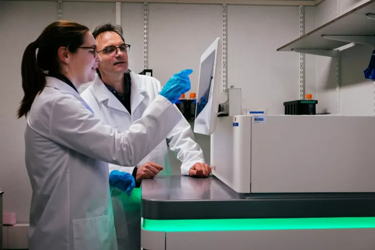 Scientists looking at a screen at the KU Leuven Genomics Core